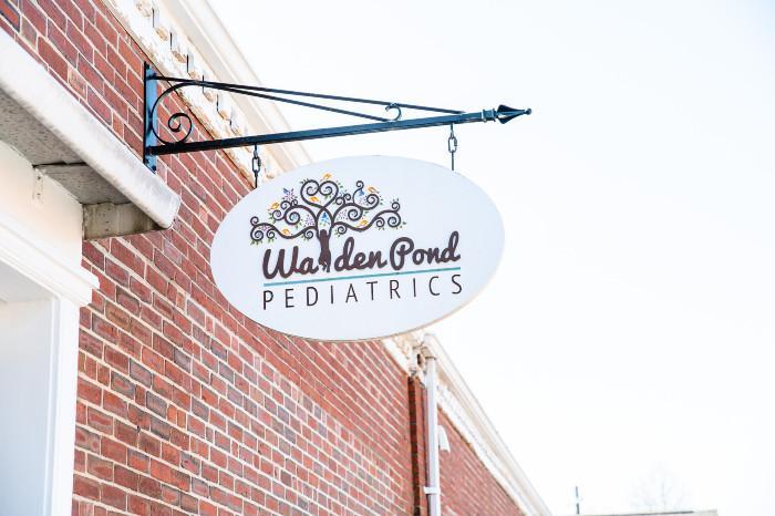 a hanging sign of walden pond pediatrics